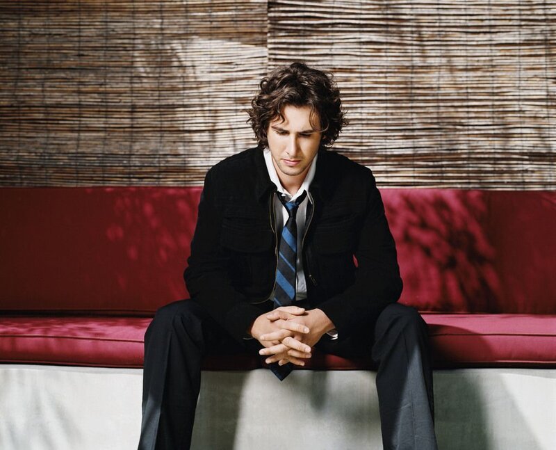 Man Sitting on Red Bench