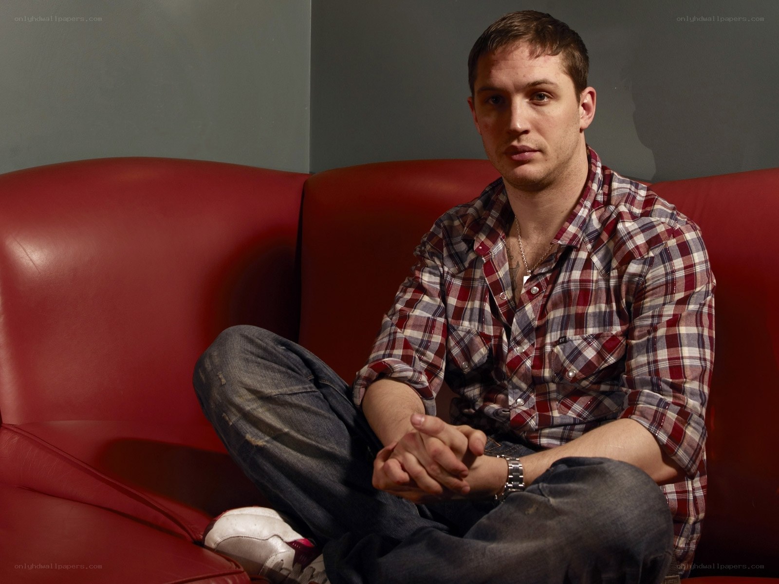 man sitting on red couch