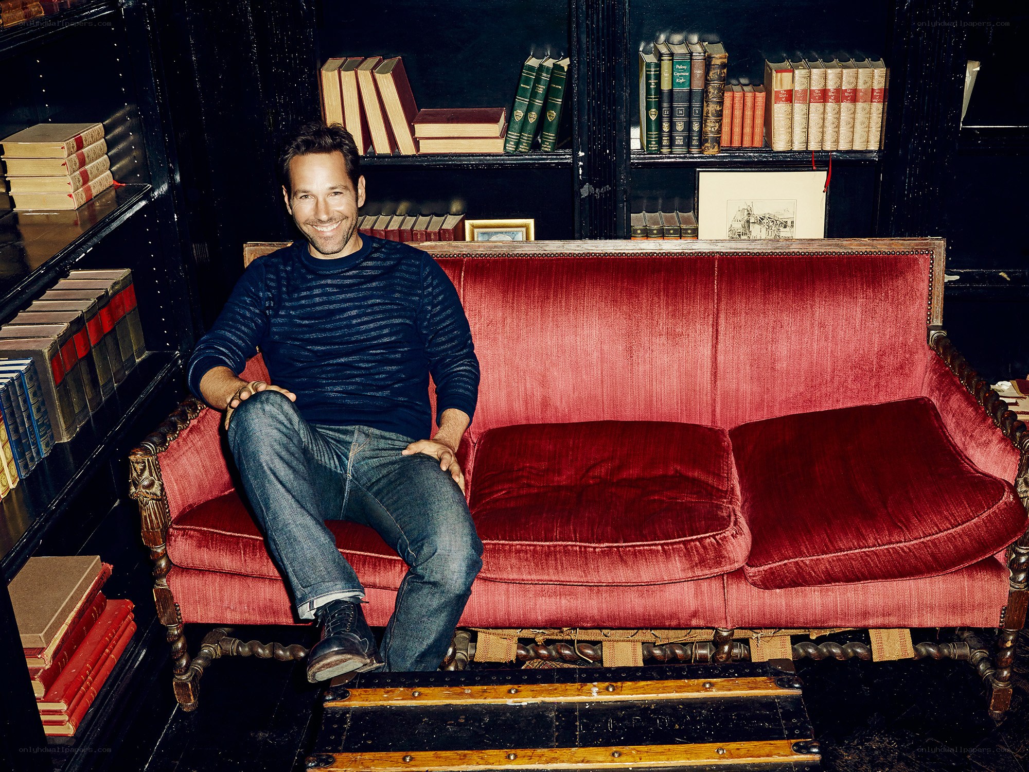 man sitting on red couch