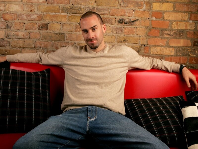 Man Sitting on Red Couch — Relaxed, Photograph