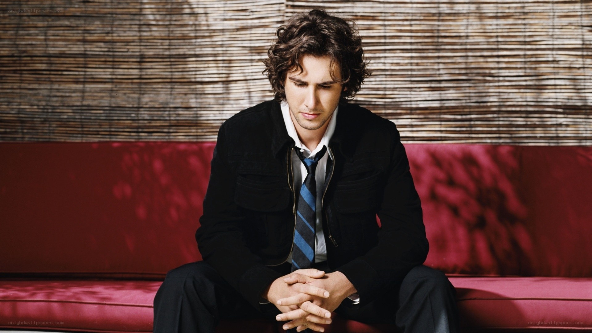 man sitting on red couch