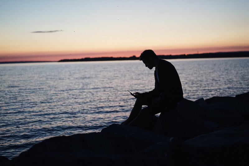 Man Sitting on Rocks — Blue, Serene