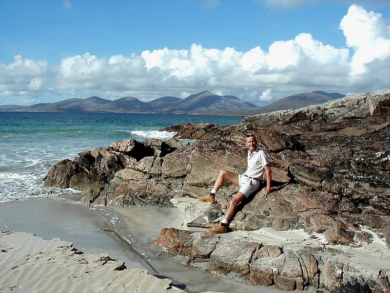 Man Sitting on Rocks — Blue