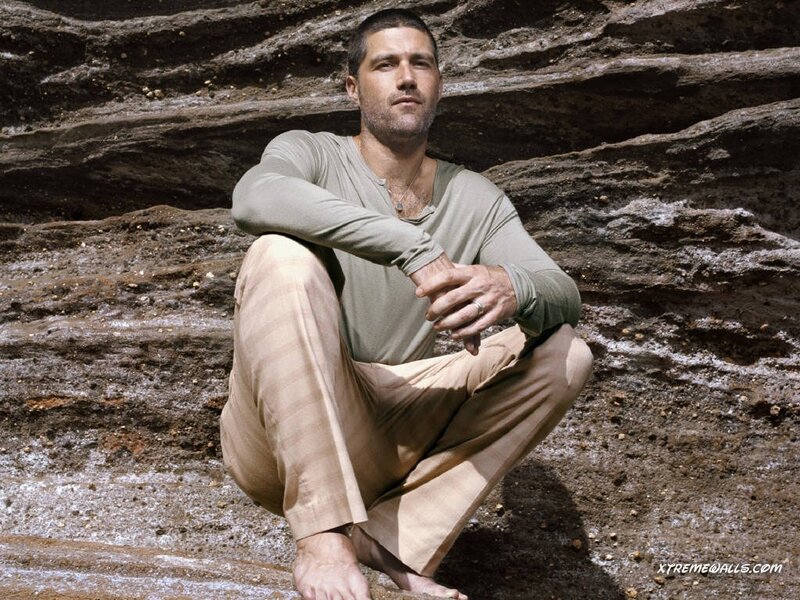 Man Sitting on Rocks — Brown