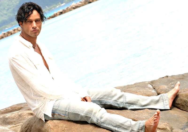 Man Sitting on Rocks — White