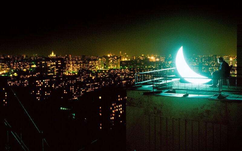 Man Sitting on Rooftop — Black
