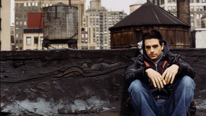 man sitting on rooftop