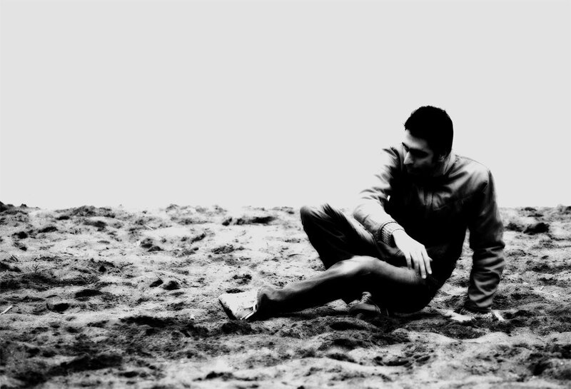 Man Sitting on Sand