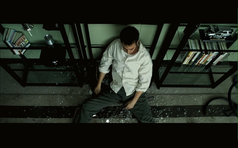 Man sitting on shattered glass