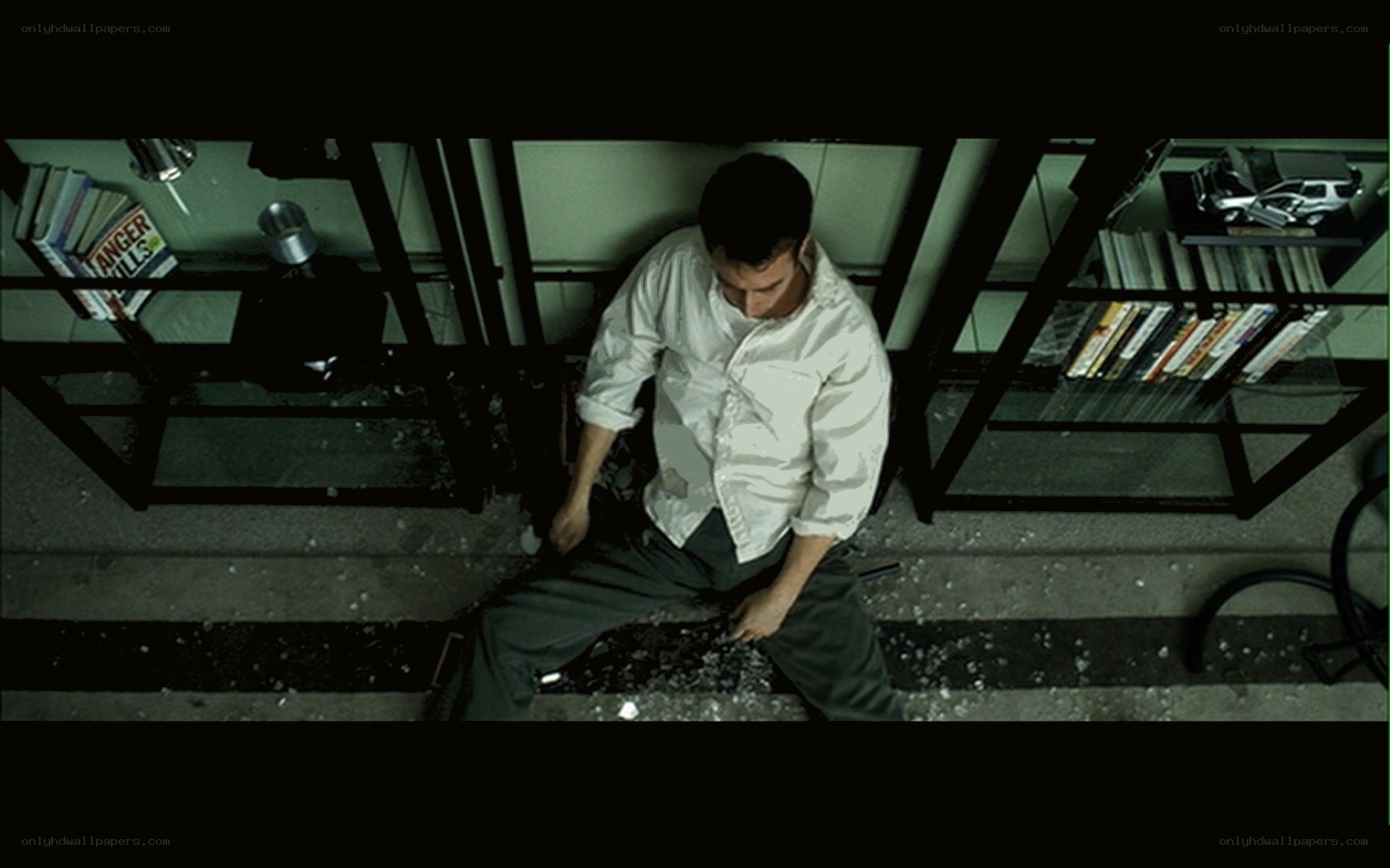 Man sitting on shattered glass