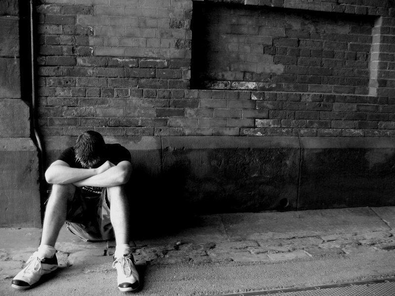 Man Sitting on Sidewalk — Black