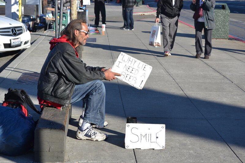 Man Sitting on Sidewalk — Gray