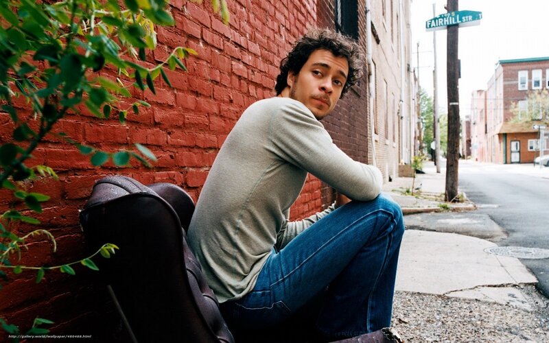 Man Sitting on Sidewalk — Red