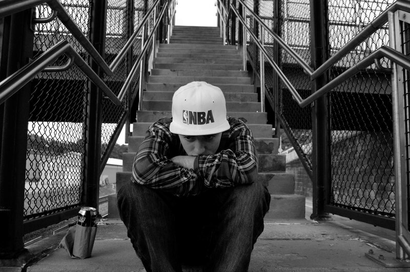 Man sitting on stairs in black and white