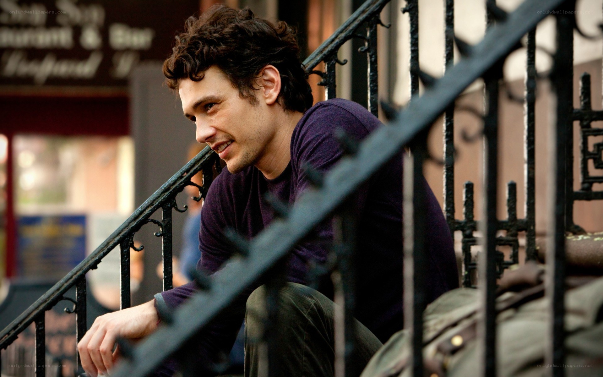 man sitting on stairs smiling
