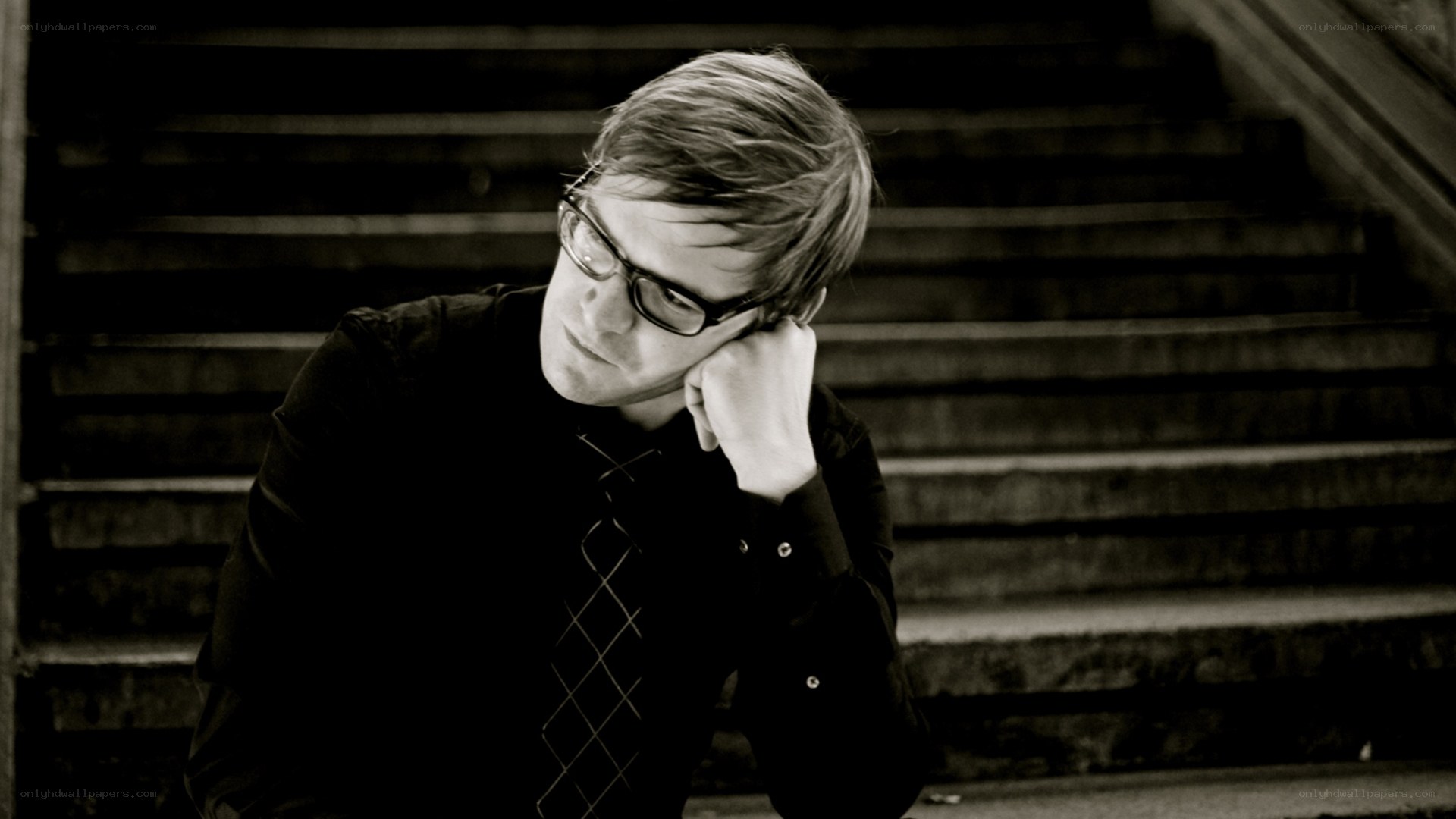 man sitting on stairs thinking