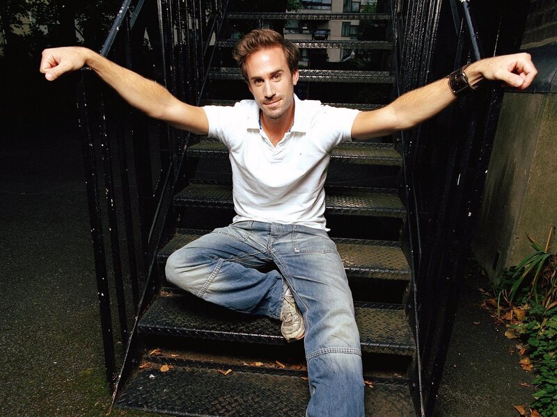 Man Sitting on Stairs — White, Confident