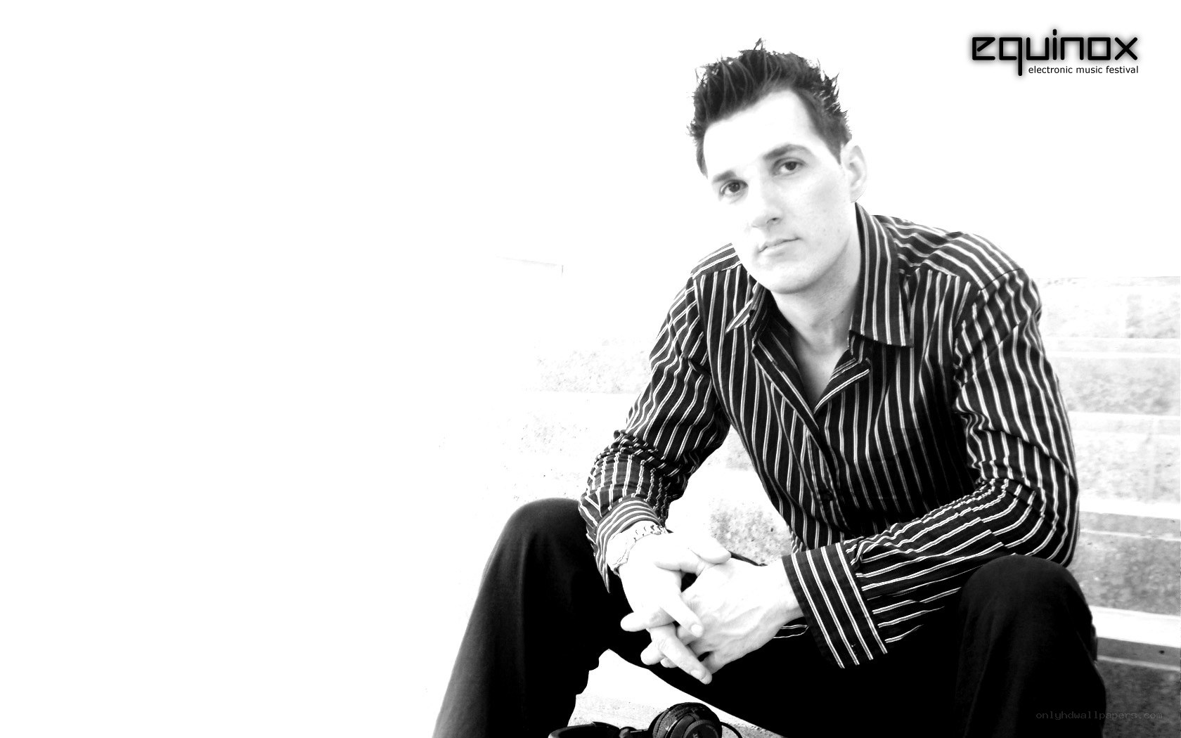 man sitting on steps in black and white