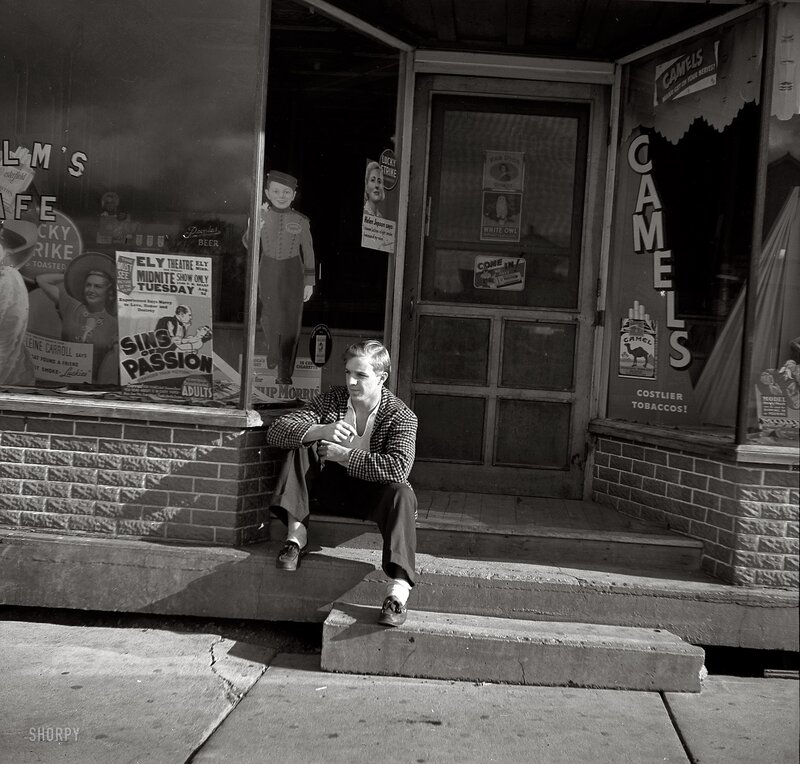 Man sitting on store steps