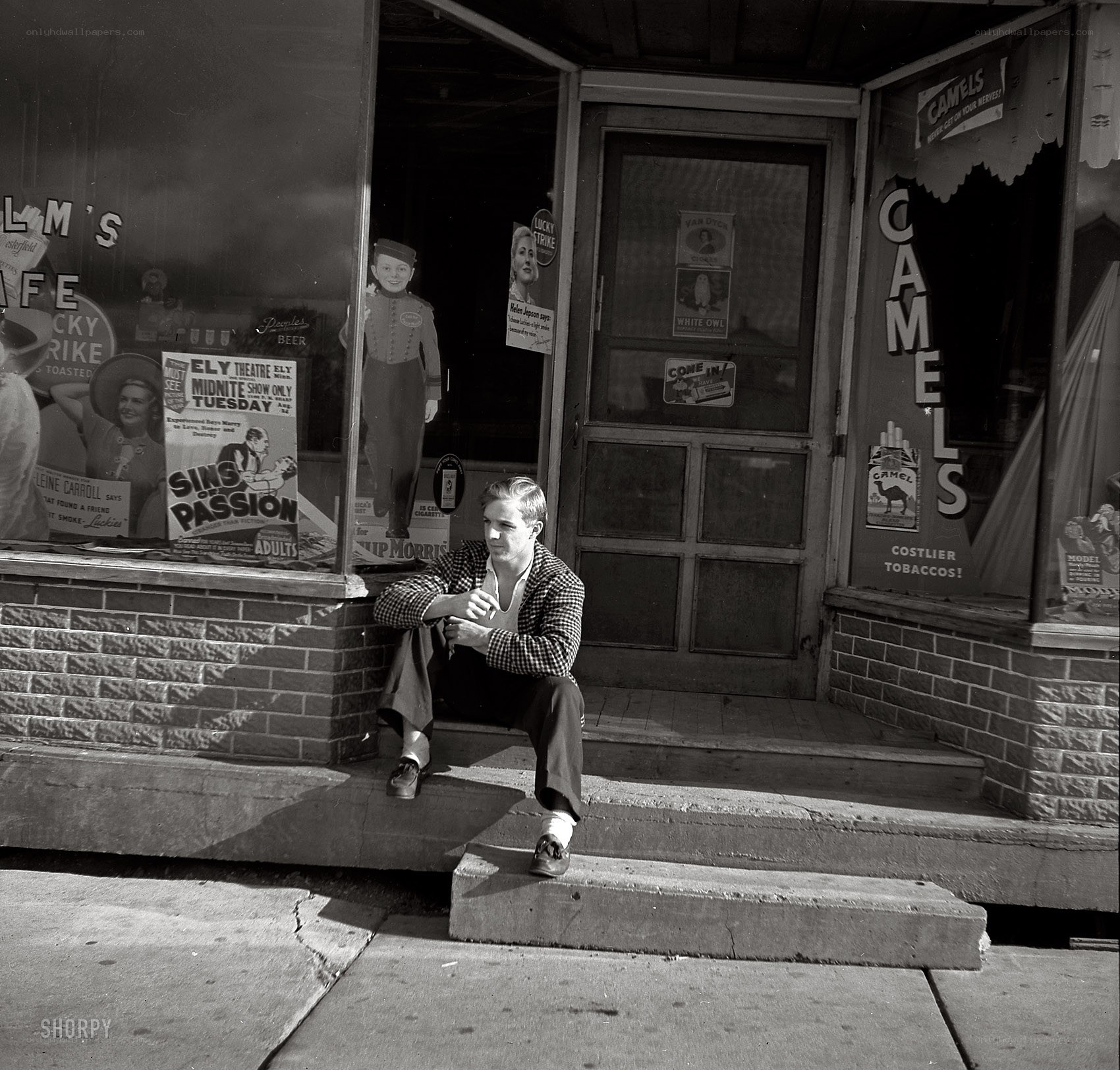 Man sitting on store steps