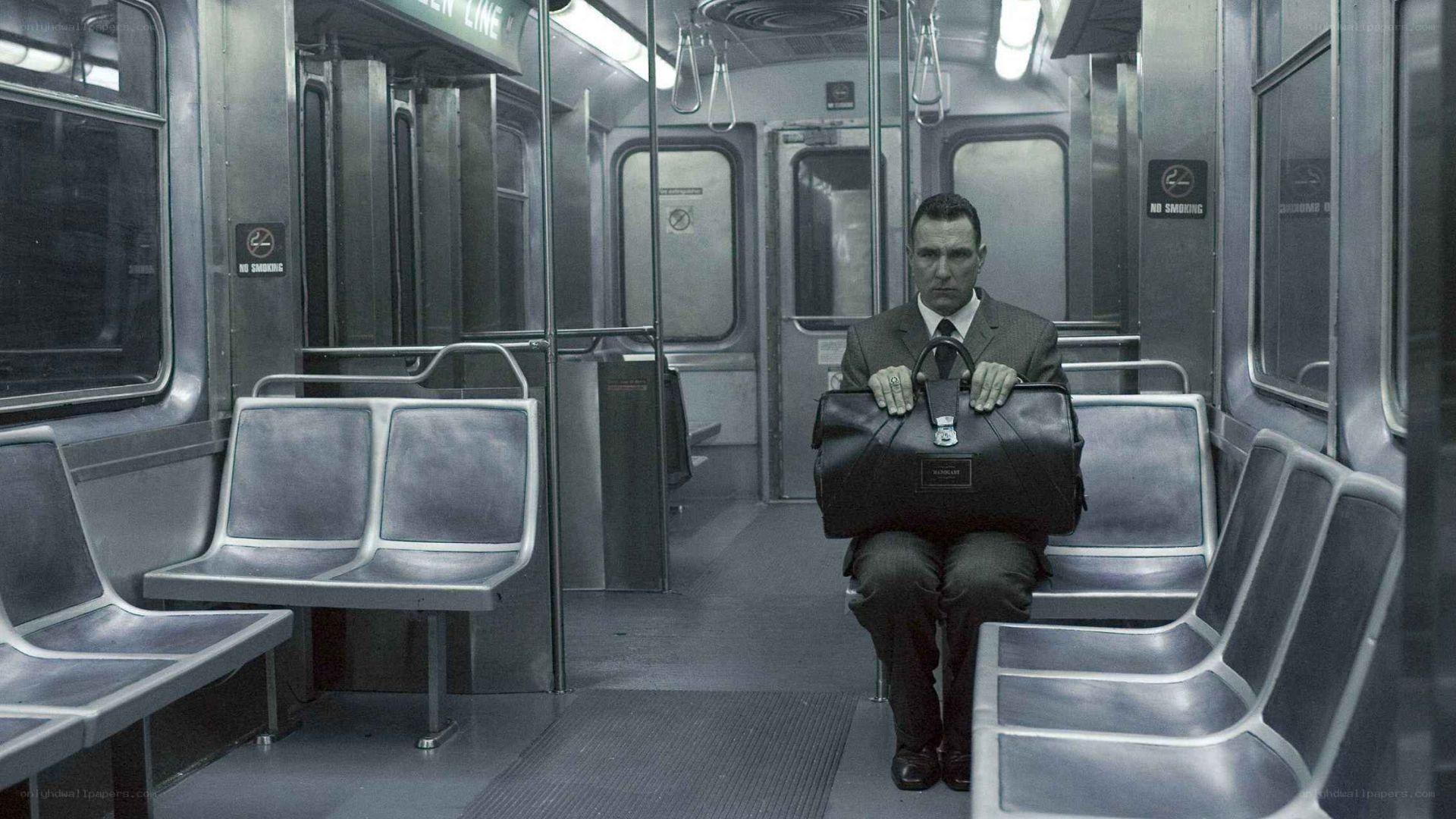 man sitting on subway train