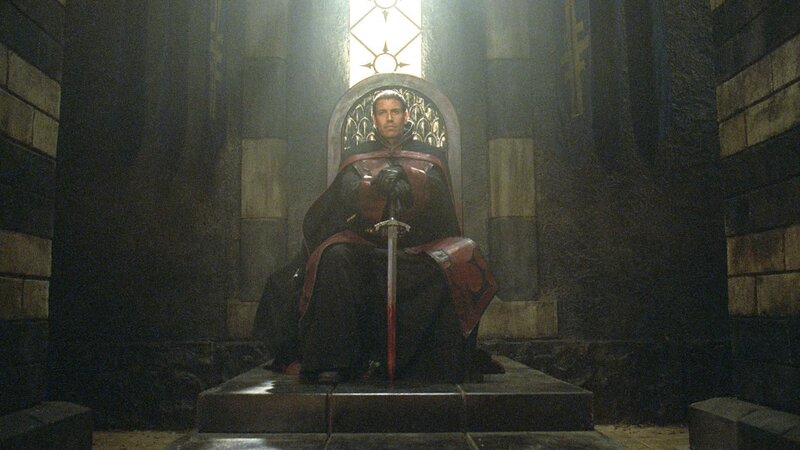 man sitting on throne with sword