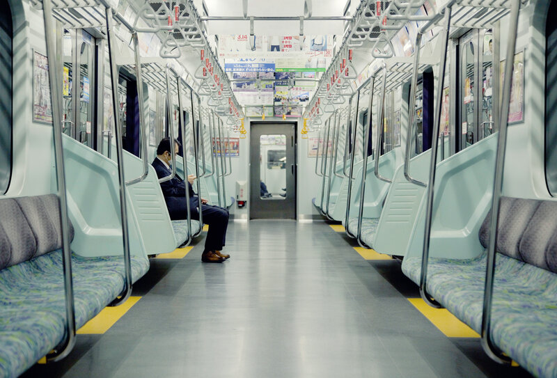 Man Sitting on Train — Gray