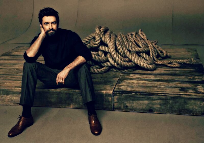Man Sitting on Wooden Platform