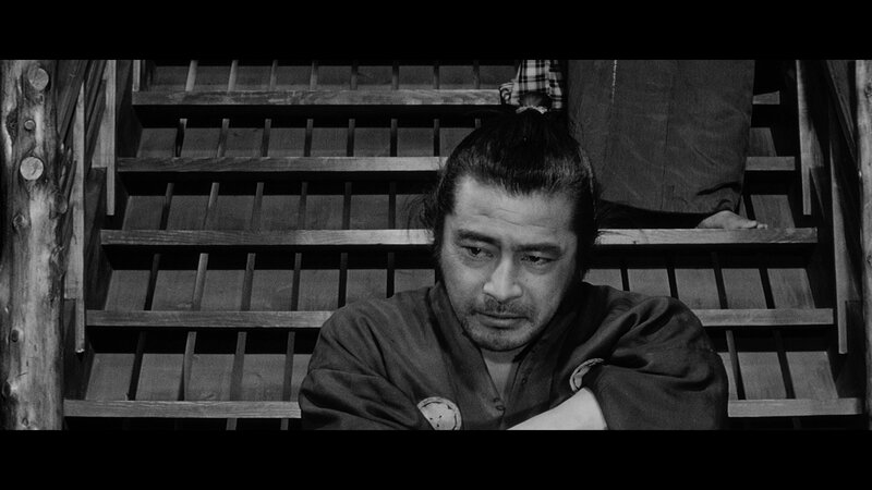 man sitting on wooden stairs