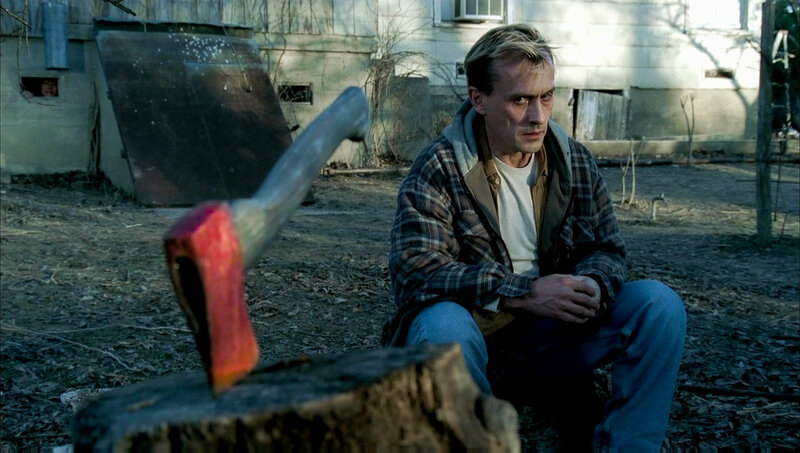 Man Sitting with Axe