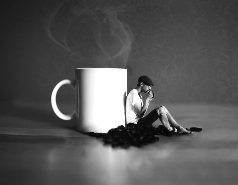 Man Sitting with Coffee Cup