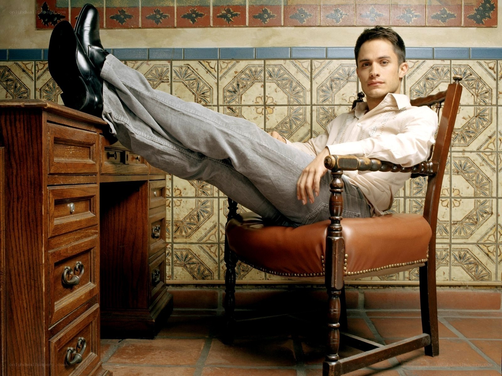man sitting with feet on desk