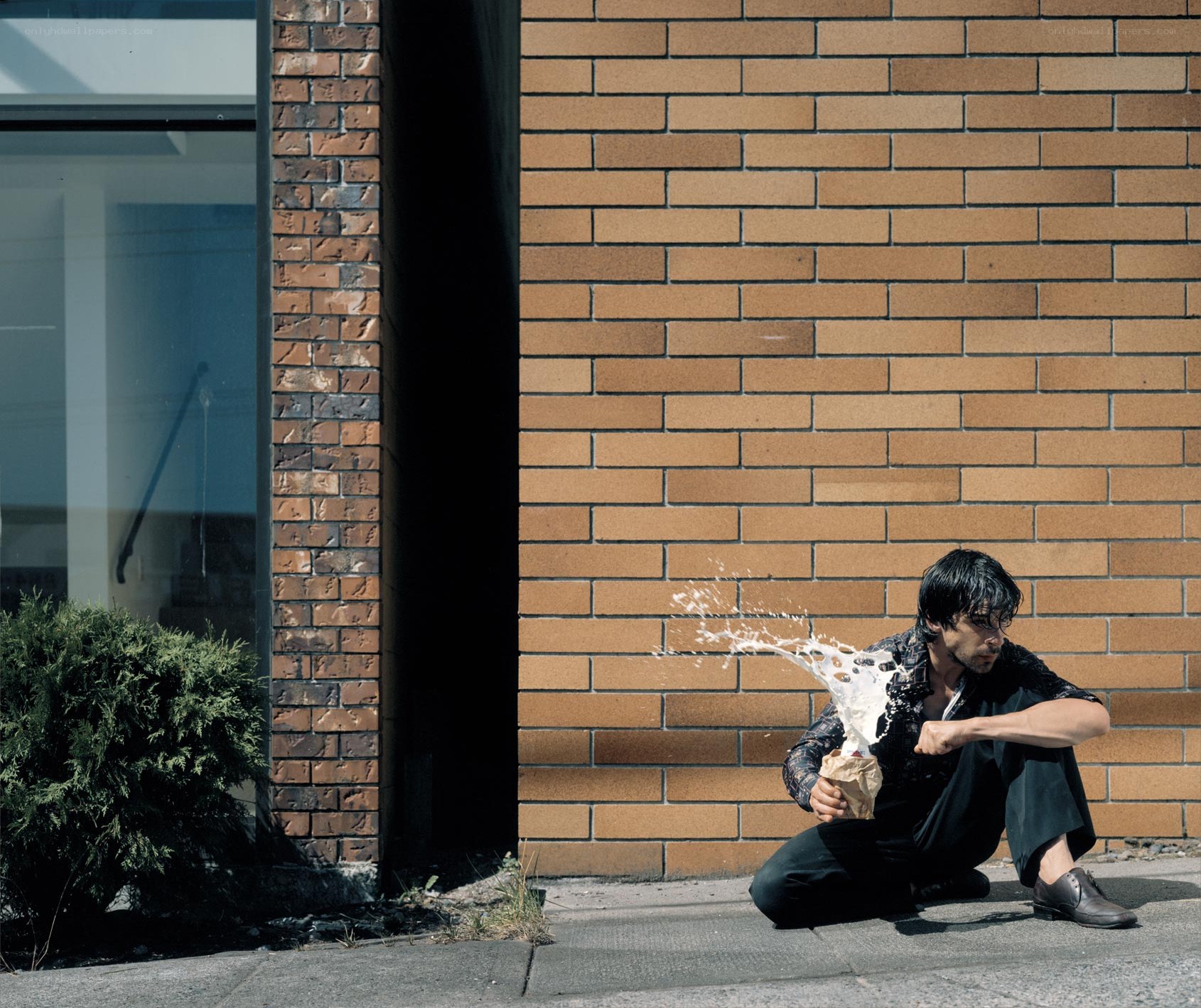 Man sitting with splashing liquid