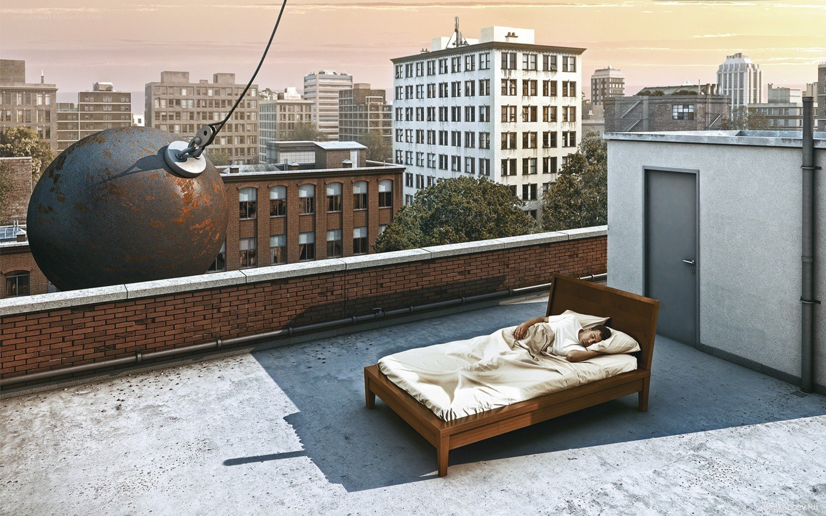 Man sleeping on rooftop with wrecking ball