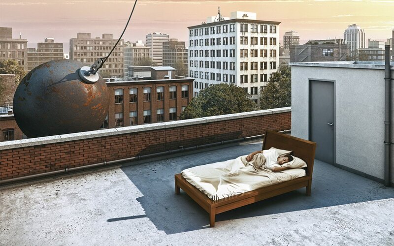 Man sleeping on rooftop with wrecking ball