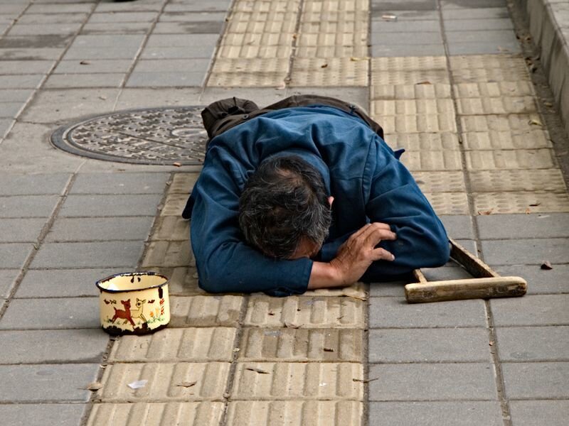 Man Sleeping on Sidewalk