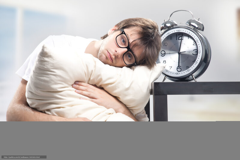 man sleeping with alarm clock