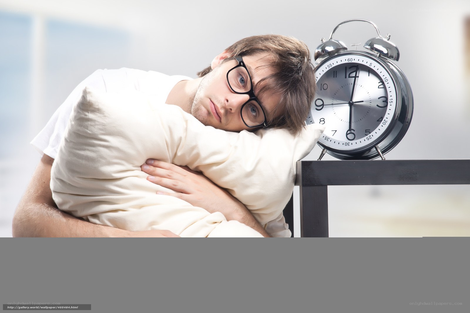 man sleeping with alarm clock