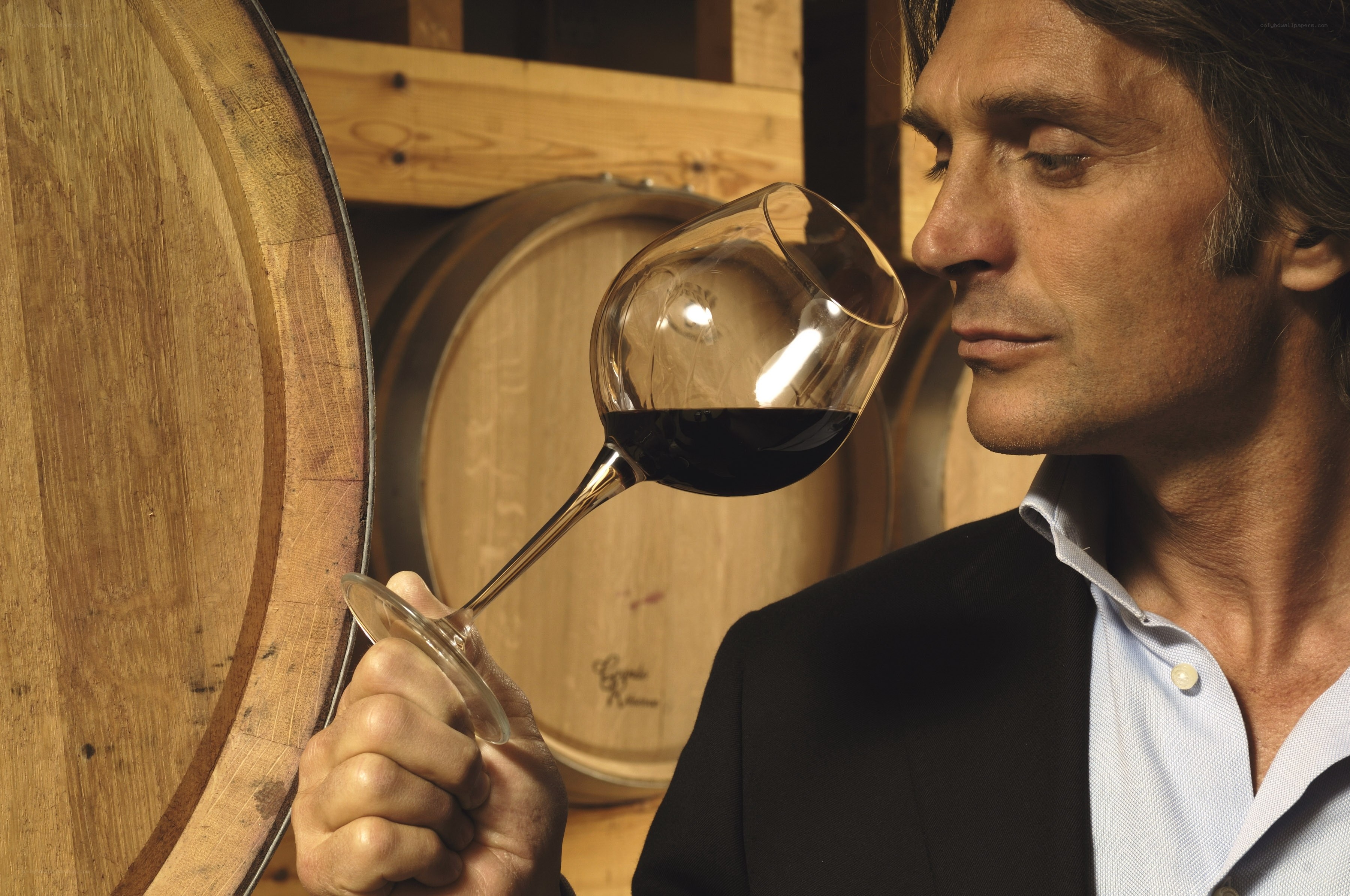 man smelling red wine