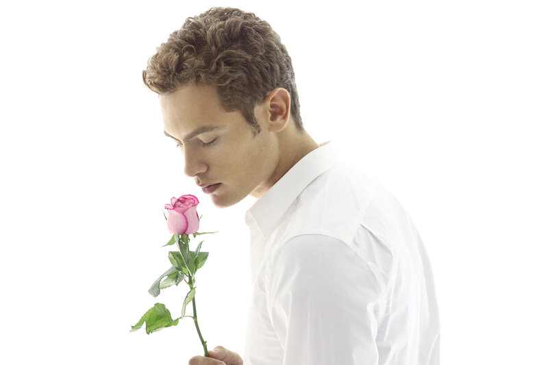 Man Smelling Rose