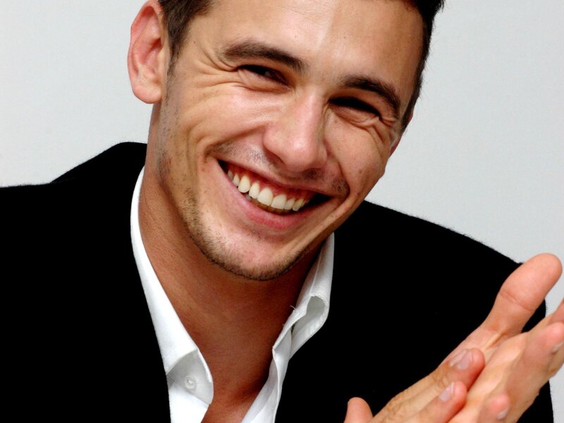 man smiling and clapping