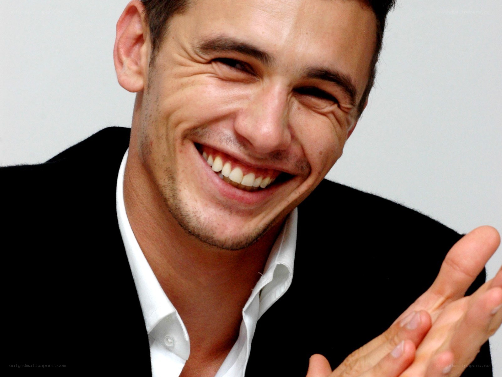 man smiling and clapping