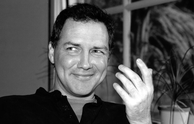 man smiling and waving