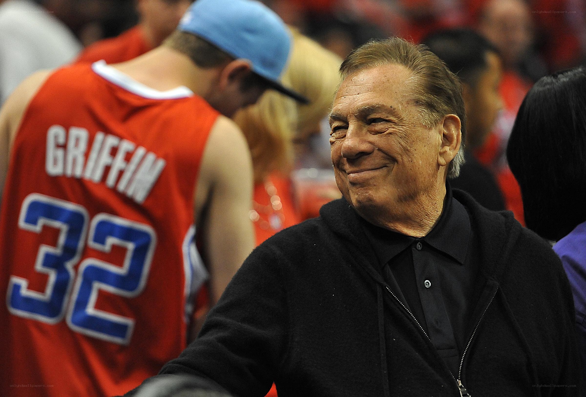 Man smiling at basketball game
