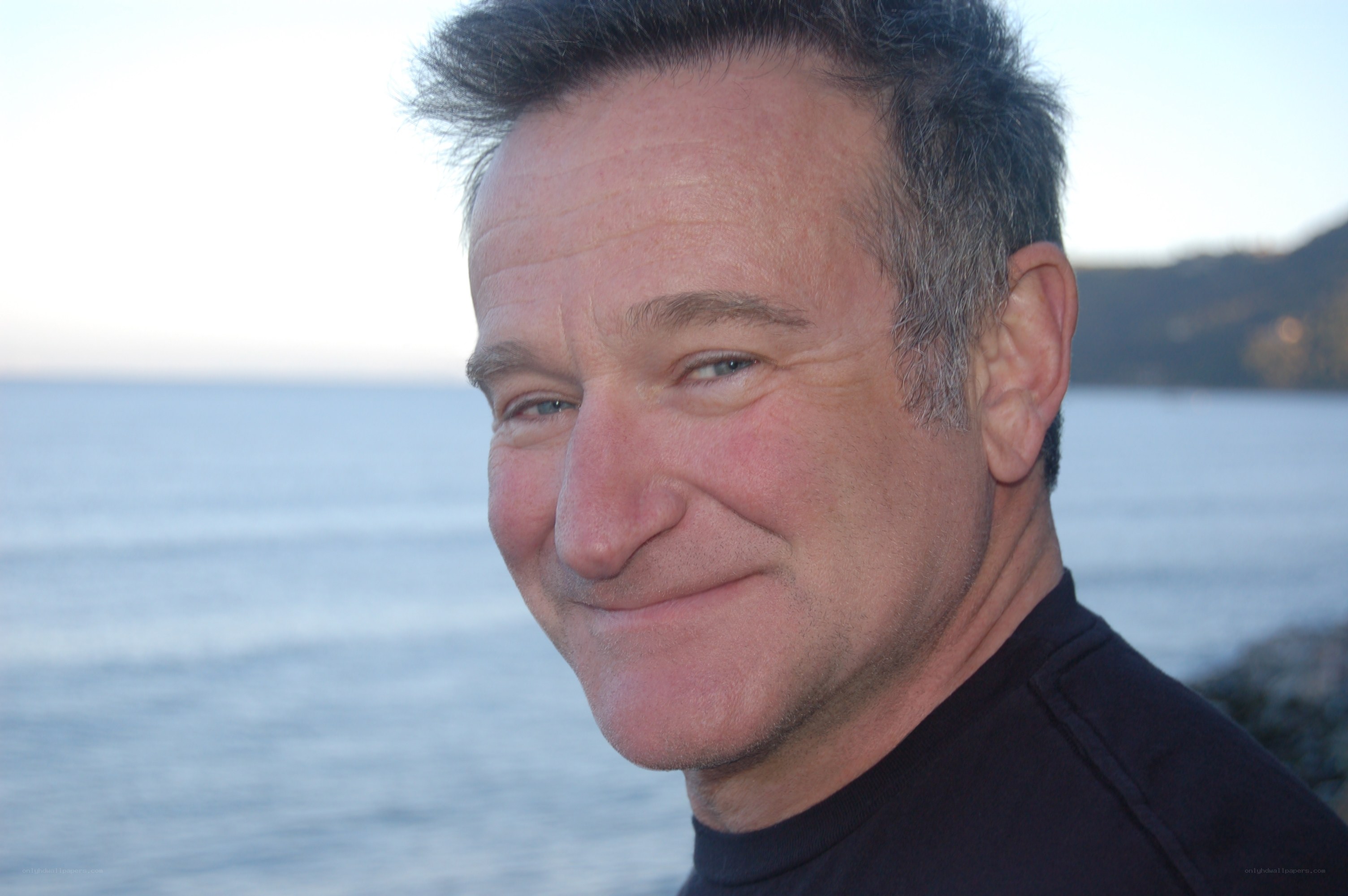 man smiling by the sea