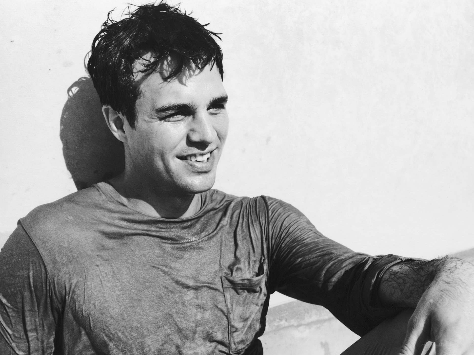 man smiling in black and white