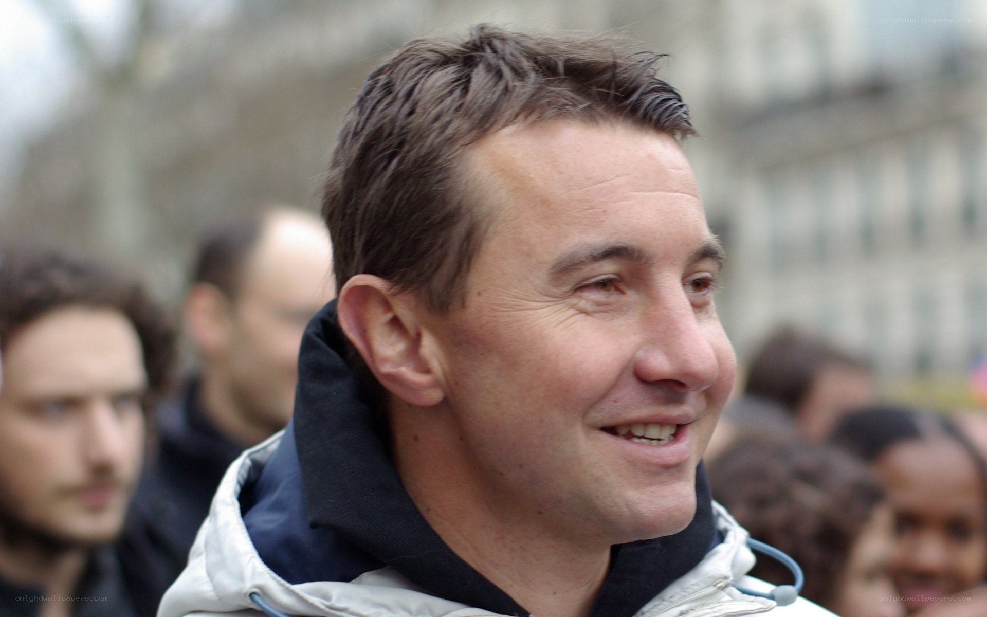 man smiling in crowd