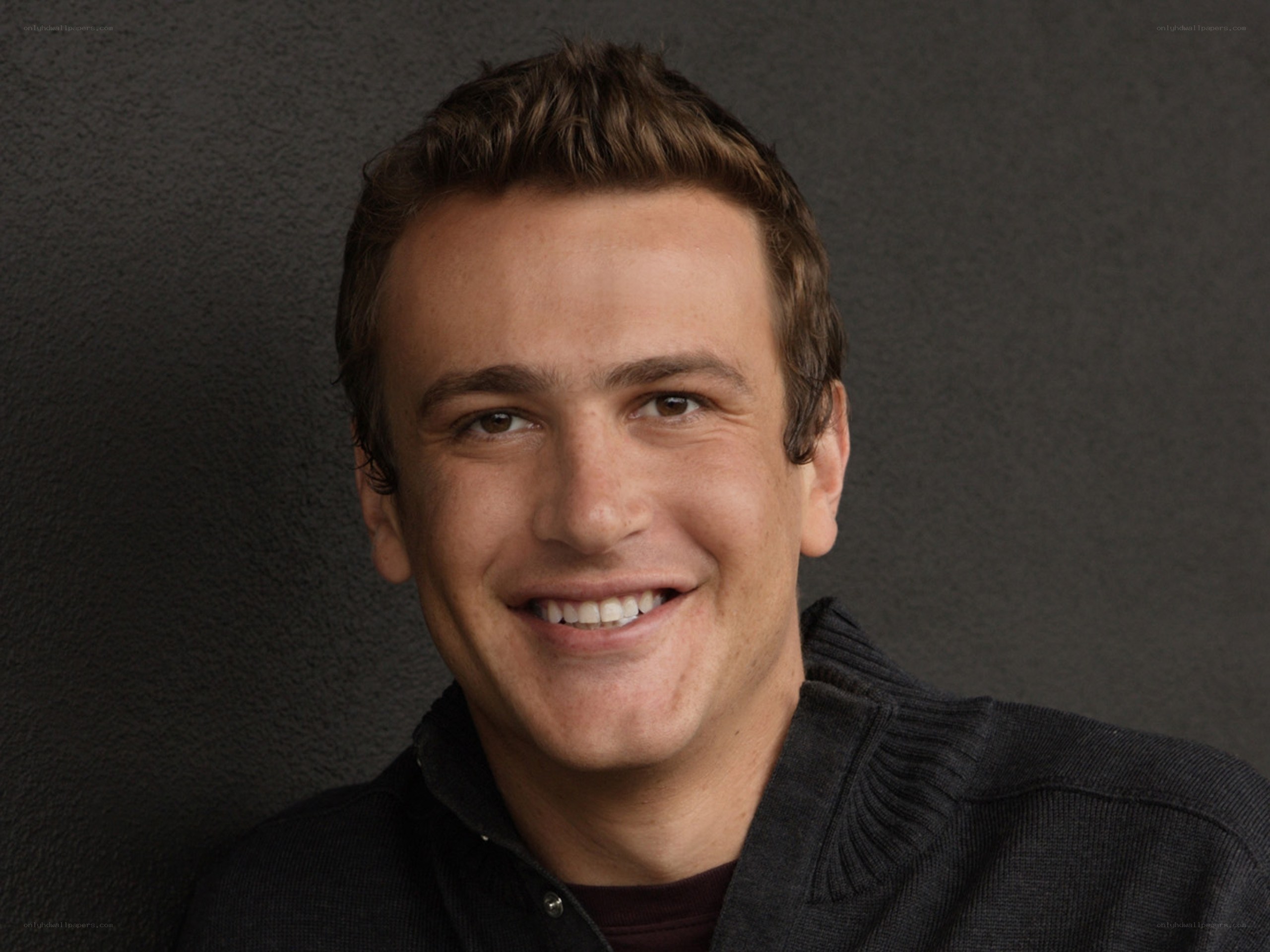 man smiling in dark sweater