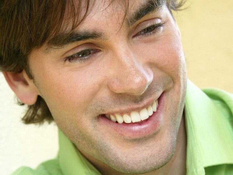 man smiling in green shirt