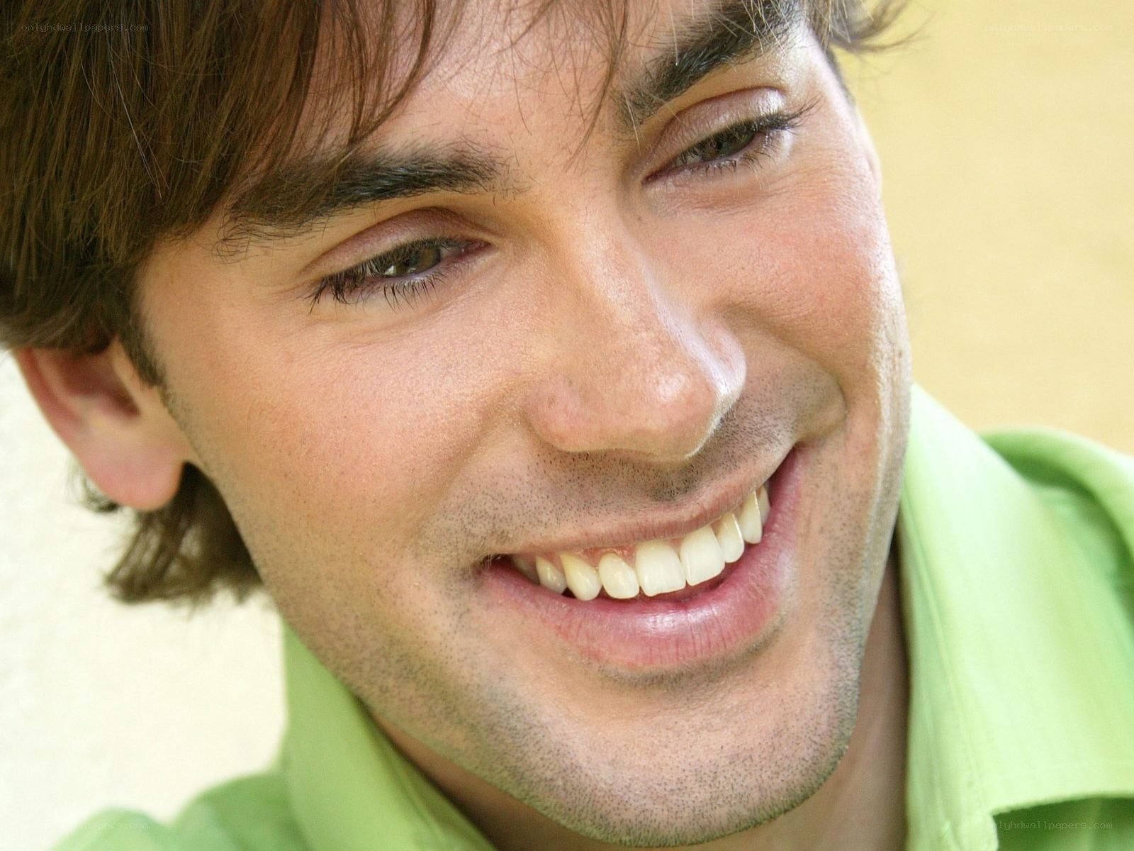 man smiling in green shirt